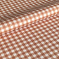 a sheet of wrapping paper with a cinnamon brown gingham pattern