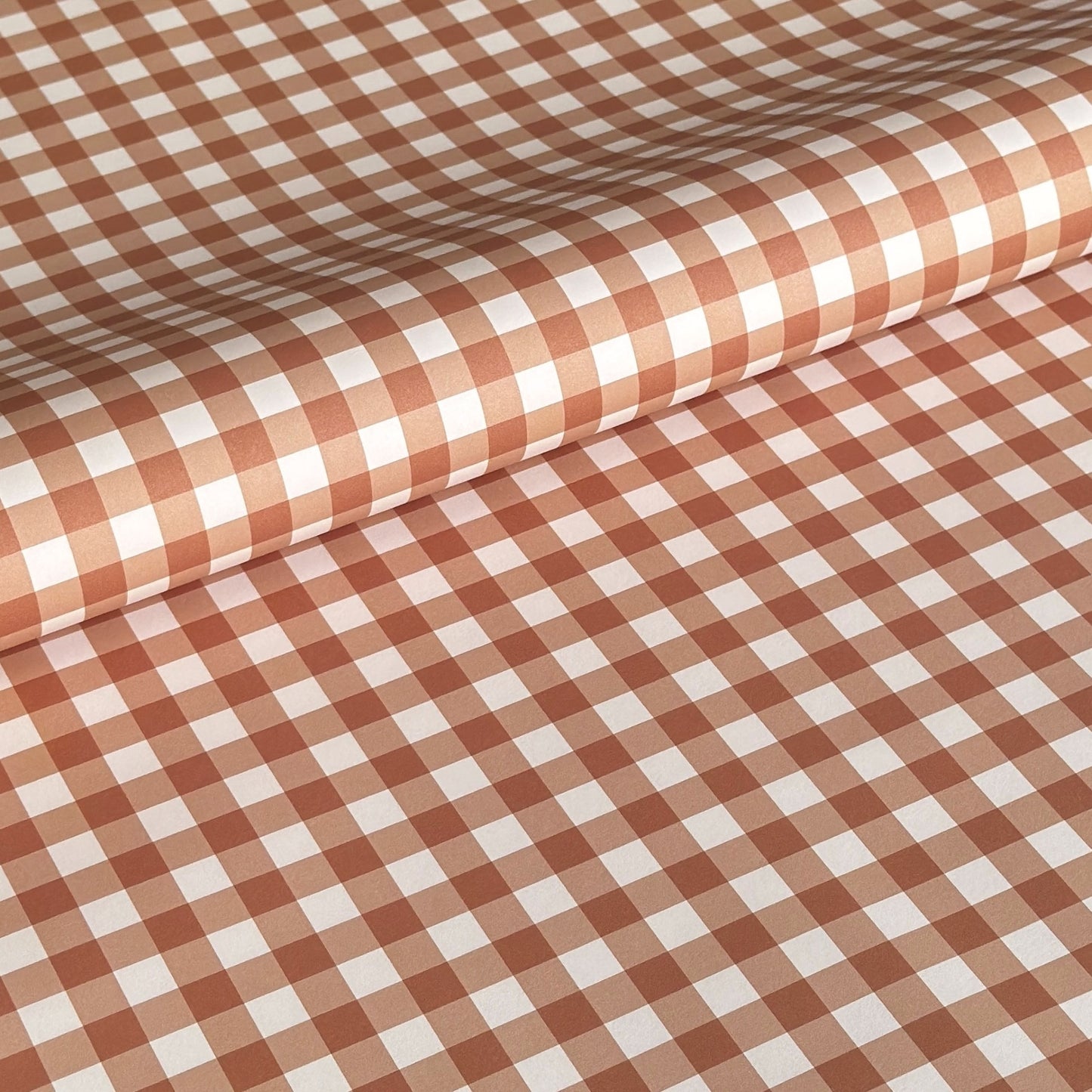 a sheet of wrapping paper with a cinnamon brown gingham pattern