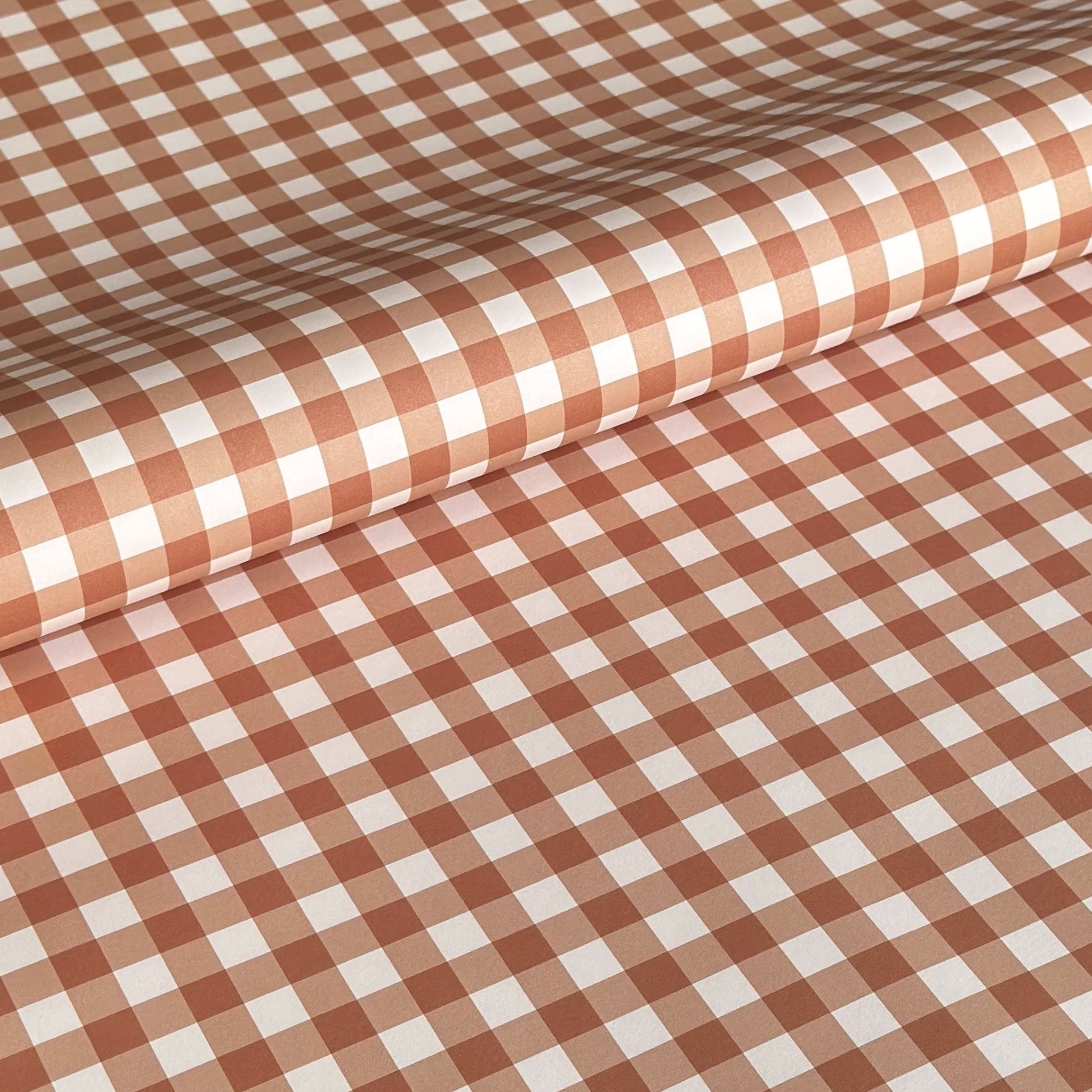 a sheet of wrapping paper with a cinnamon brown gingham pattern