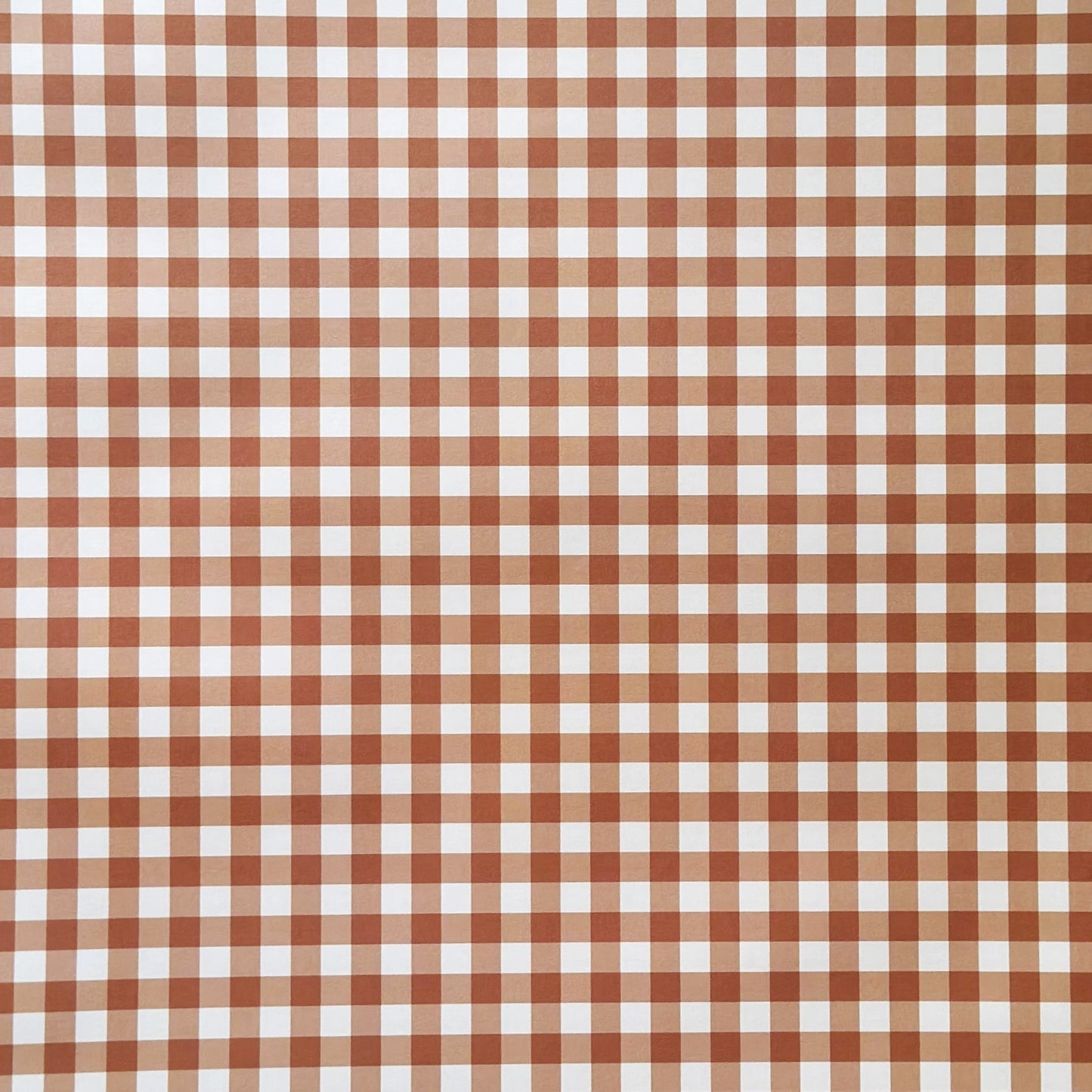 a sheet of wrapping paper with a cinnamon brown gingham pattern