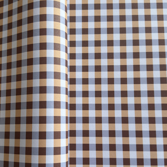 a sheet of wrapping paper with a gingham pattern in brown, beige and light blue