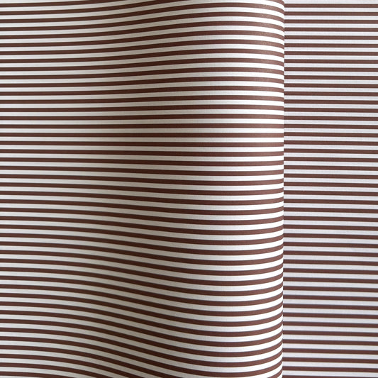 a sheet of wrapping paper with a narrow stripe design in dark brown and cream