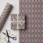a sheet of wrapping paper with a brown line pattern in brown and beige