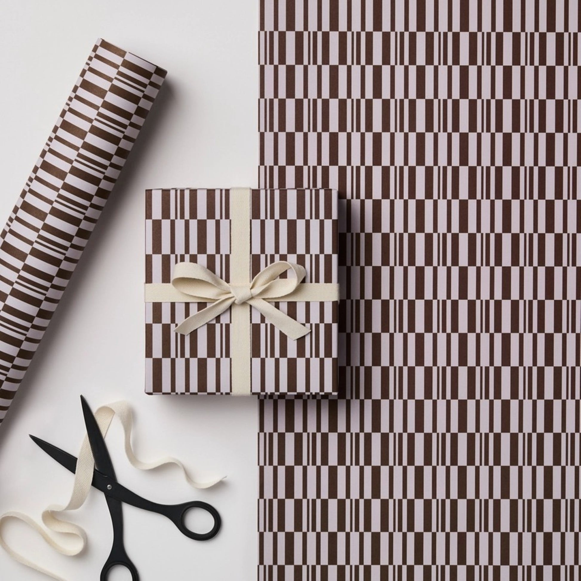 a sheet of wrapping paper with a brown line pattern in brown and beige
