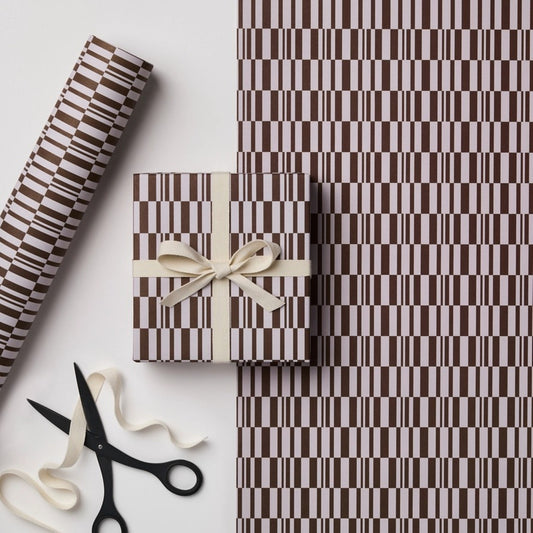 a sheet of wrapping paper with a brown line pattern in brown and beige