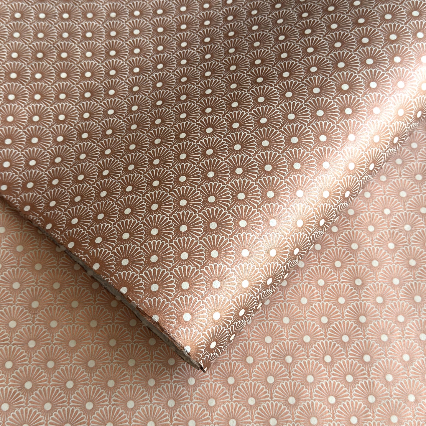 Nepalese handmade decorative lokta paper sheet with a copper metallic repeat floral pattern screen printed on an ivory lokta paper.