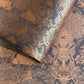 Nepalese handmade decorative lokta paper sheet with a detailed design of trees and flowers in copper screen printed on a dusty violet lokta paper.