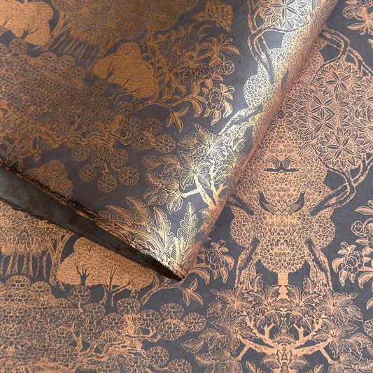 Nepalese handmade decorative lokta paper sheet with a detailed design of trees and flowers in copper screen printed on a dusty violet lokta paper.