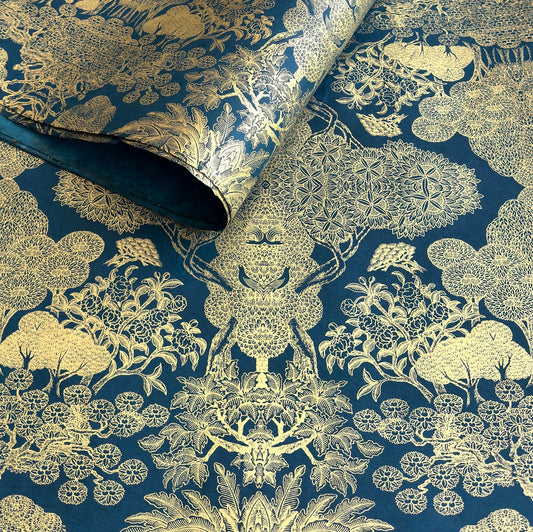 Nepalese handmade decorative lokta paper sheet with a detailed design of trees and flowers in gold metallic screen printed on a midnight blue lokta paper.