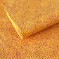 a sheet of screen printed Nepalese lokta paper with a repeat floral design in dark orange on an amber yellow lokta paper 