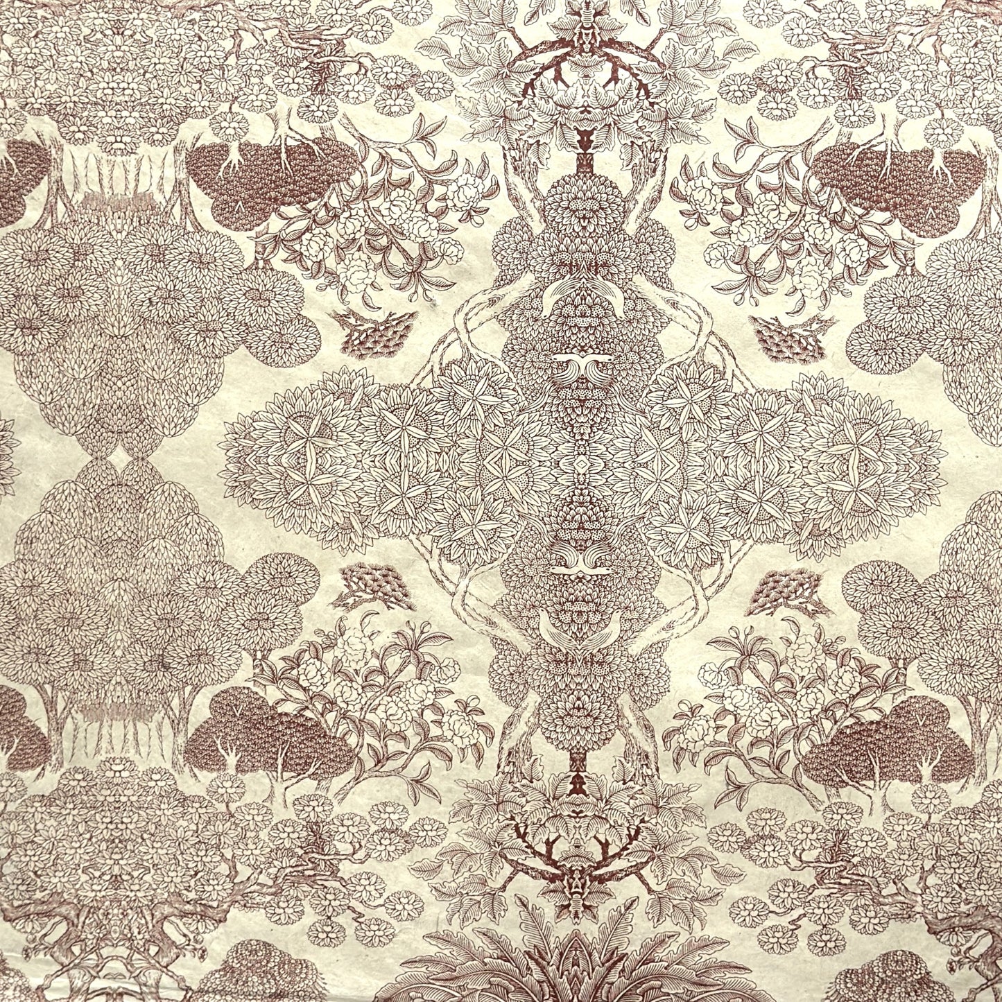 A sheet of Nepalese handprinted Lokta paper with a detailed pattern of trees and flowers in sepia on an ecru base.