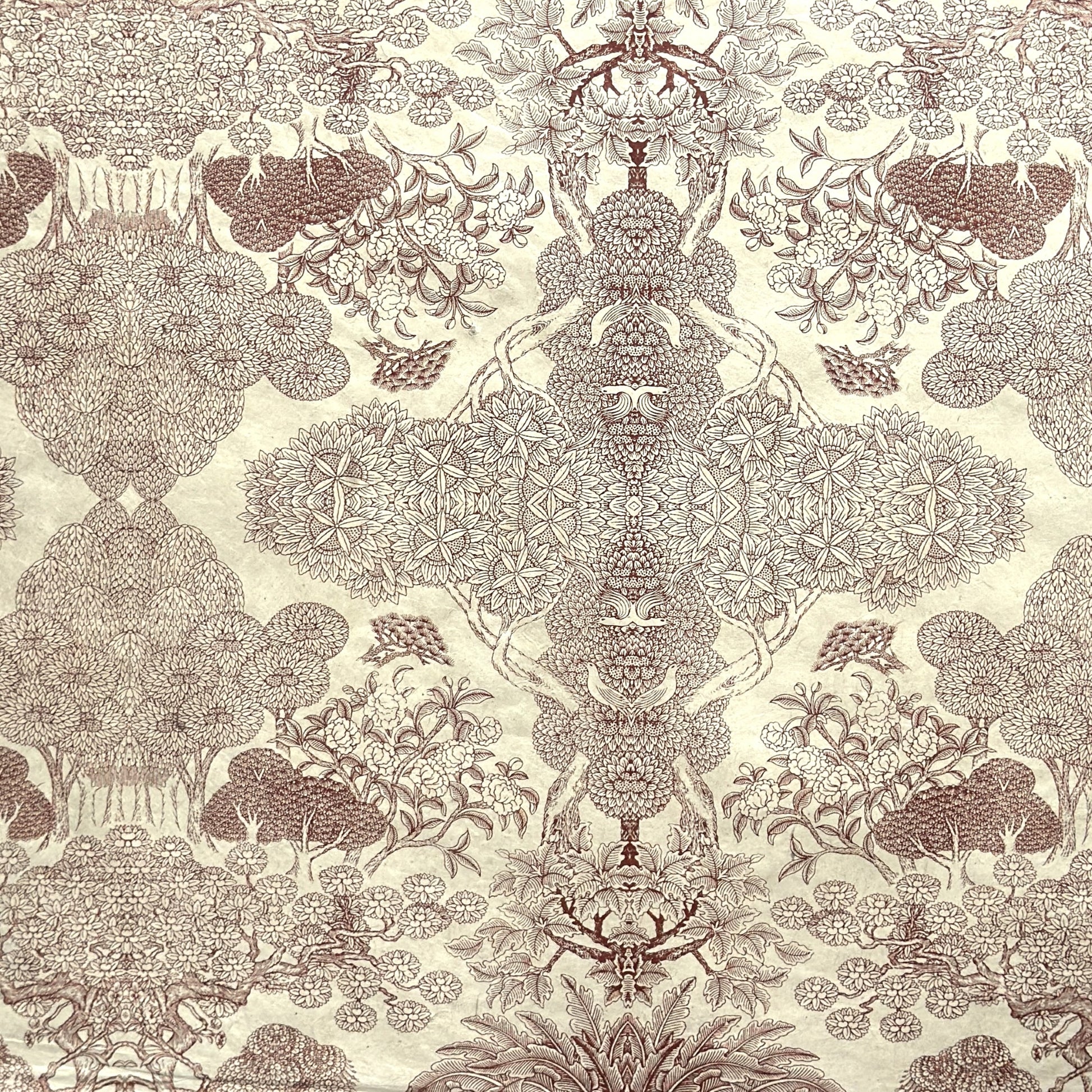 A sheet of Nepalese handprinted Lokta paper with a detailed pattern of trees and flowers in sepia on an ecru base.