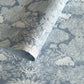 a sheet of Nepalese lokta paper in sky blue with a detailed pattern of trees and flowers screen printed in white