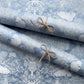 a sheet of Nepalese lokta paper in sky blue with a detailed pattern of trees and flowers screen printed in white