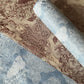 a sheet of Nepalese lokta paper in sky blue with a detailed pattern of trees and flowers screen printed in white