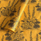 A Toile de Jouy style drawing of an agapanthus in brown screen-printed by hand on mustard yellow lokta paper.