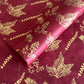 Nepalese handmade decorative lokta paper sheet with gold leaves screen printed on a burgundy red lokta paper