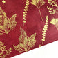 Nepalese handmade decorative lokta paper sheet with gold leaves screen printed on a burgundy red lokta paper, close up