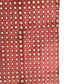 a sheet of Nepalese batik lokta paper in coral rose colour with a repeat white dot design. Close up