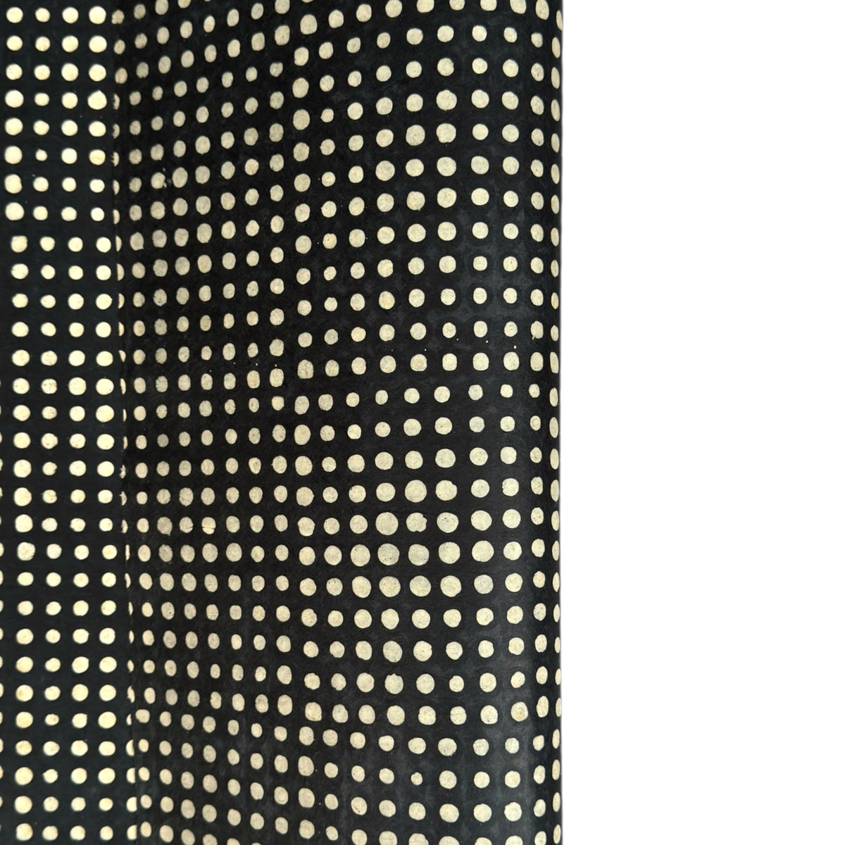 a sheet of black batik dyed Nepalese lokta paper with repeat design of white dots.  