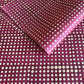 Nepalese handmade decorative lokta paper sheet with a pattern of white dots on burgundy red lokta paper.  Batik dyed using carved wooden blocks.