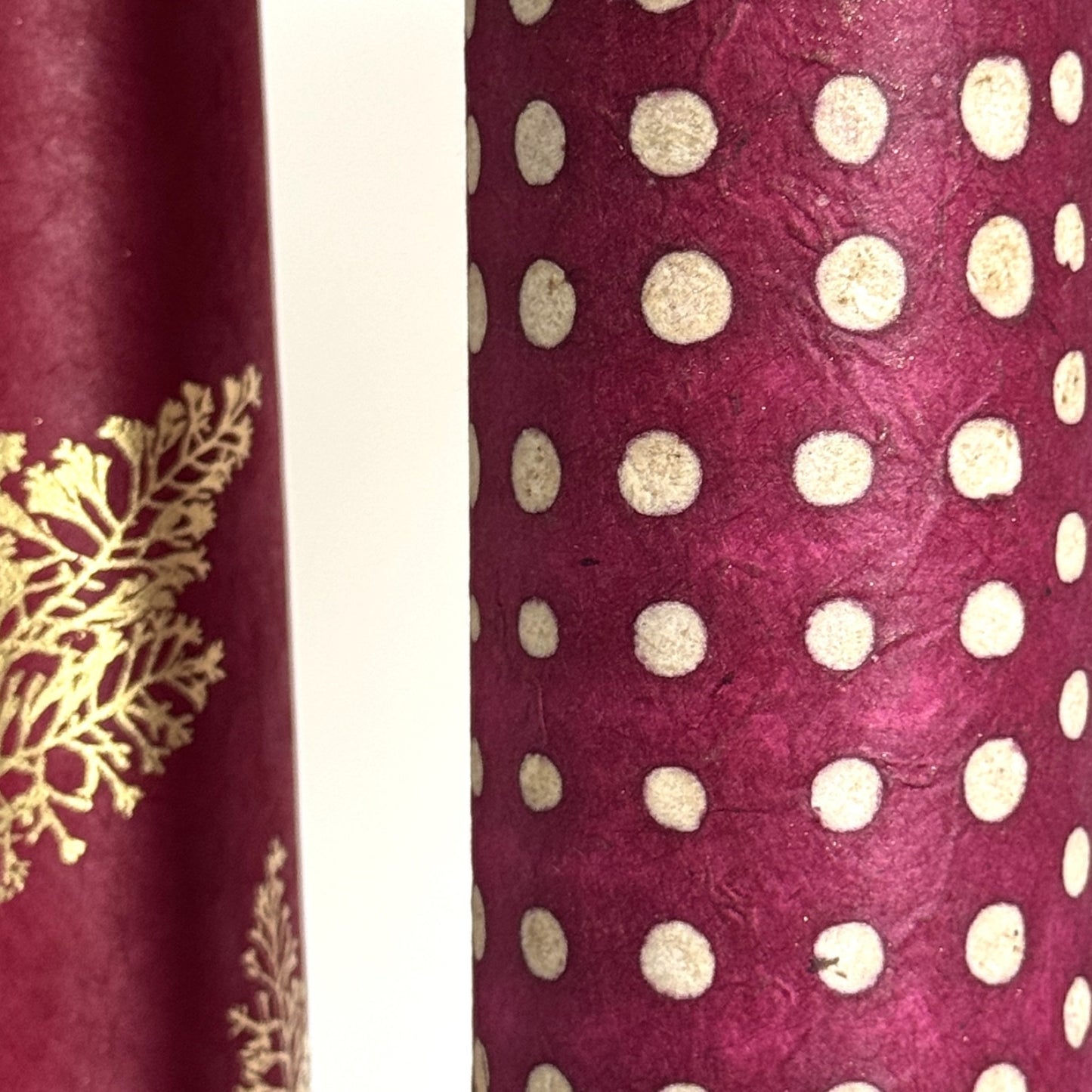 Nepalese handmade decorative lokta paper sheet with a pattern of white dots on burgundy red lokta paper.  Batik dyed using carved wooden blocks.