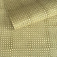 a sheet of Nepalese batik lokta paper in sage green with a repeat white dot design. 