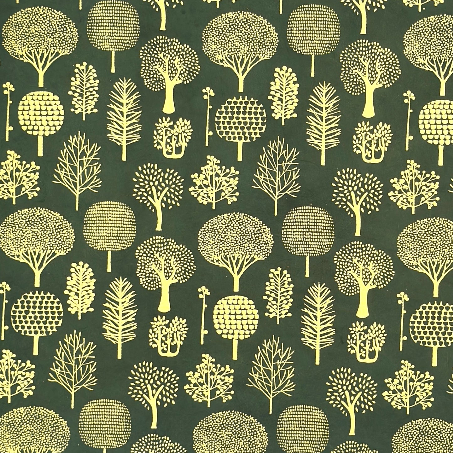 Nepalese handmade decorative lokta paper sheet with gold trees screen printed on a dark green lokta paper.