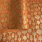 a sheet of screen printed Nepalese lokta paper in terracotta brown with gold trees.  The sheet is pictured lightly folded to show the gold of the trees and the deckled edge of the paper.