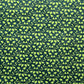 a sheet of lokta paper with a green abstract gingko design on dark green paper