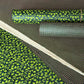 a sheet of lokta paper with a green abstract gingko design on dark green paper.  Pictured with other designs