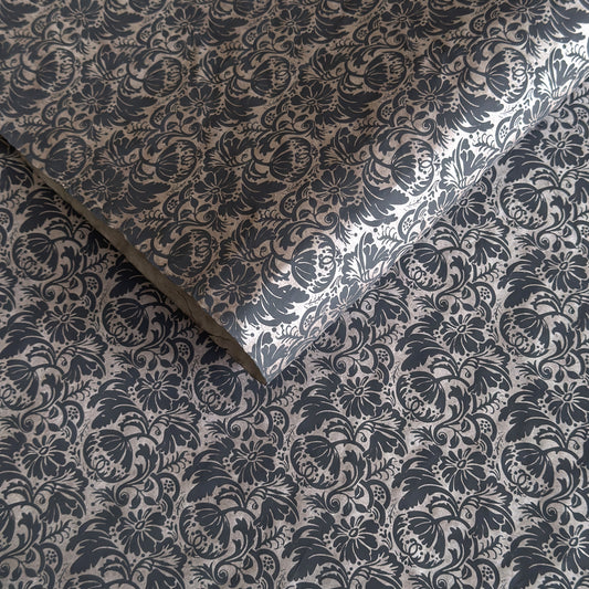Nepalese handmade decorative lokta paper sheet with a black floral pattern screen printed on a dark taupe lokta paper.