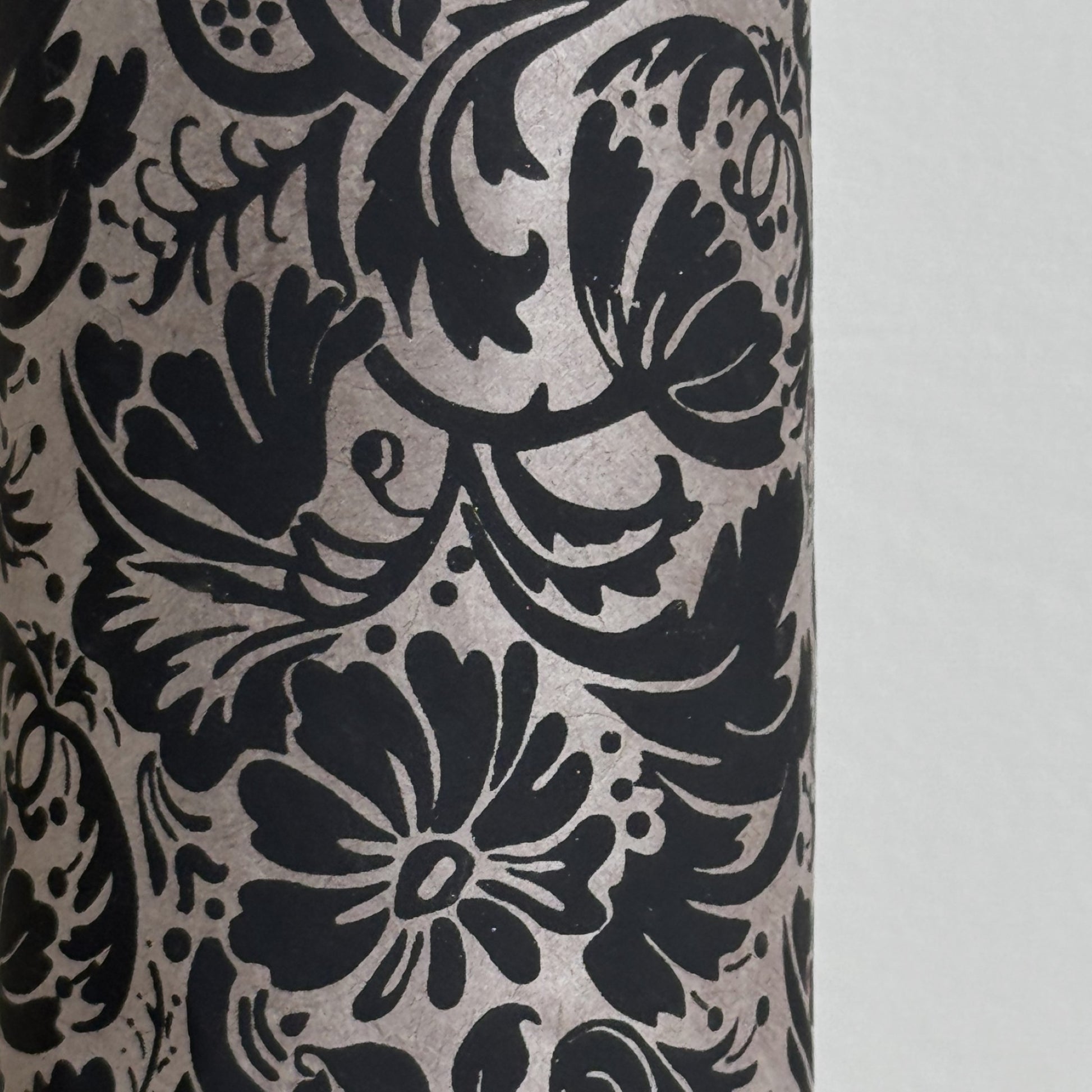 Nepalese handmade decorative lokta paper sheet with a black floral pattern screen printed on a dark taupe lokta paper.