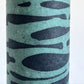 Nepalese handmade decorative lokta paper sheet with an abstract pattern in aqua and teal.  Batik dyed using carved wooden blocks. Close up