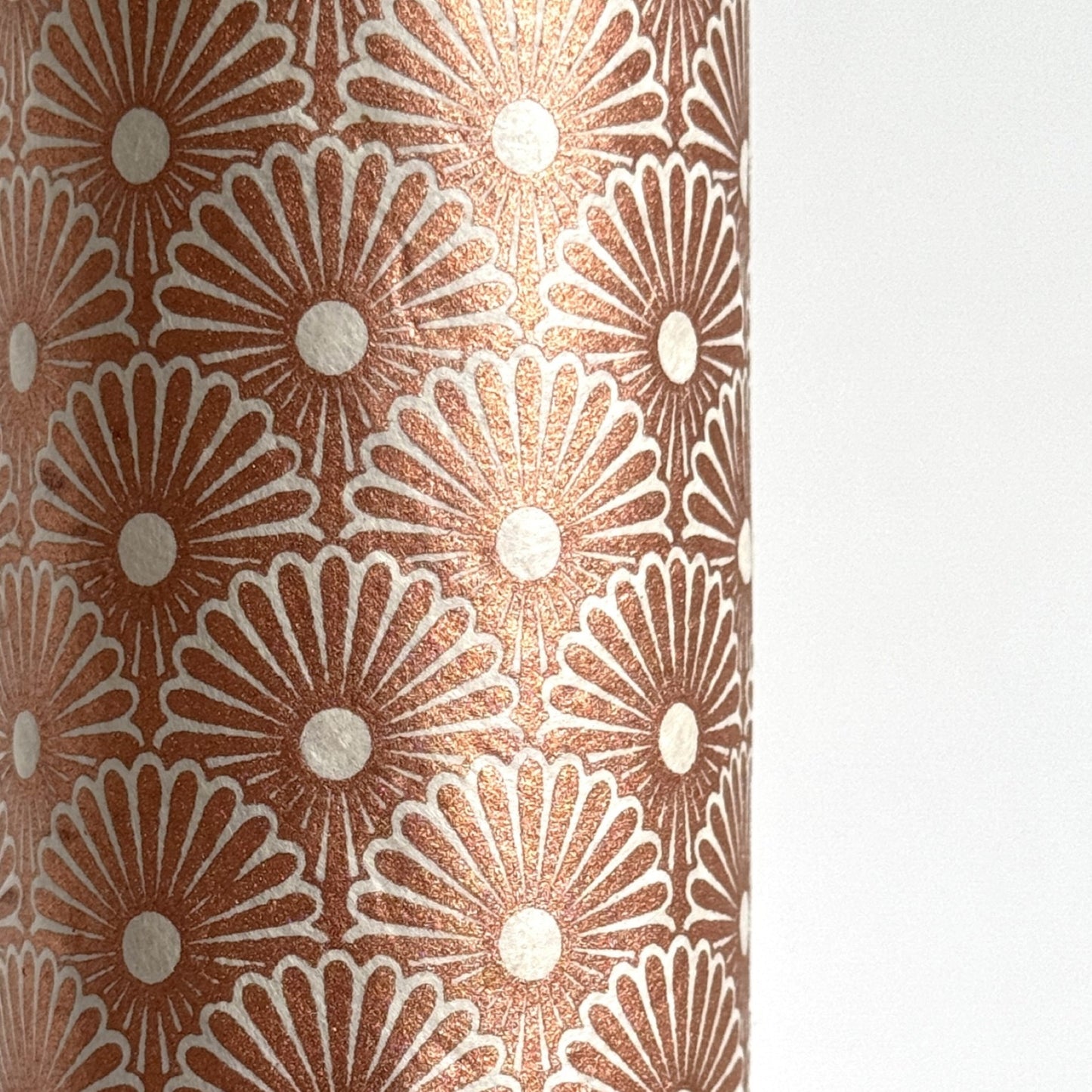 Nepalese handmade decorative lokta paper sheet with a copper metallic repeat floral pattern screen printed on an ivory lokta paper.