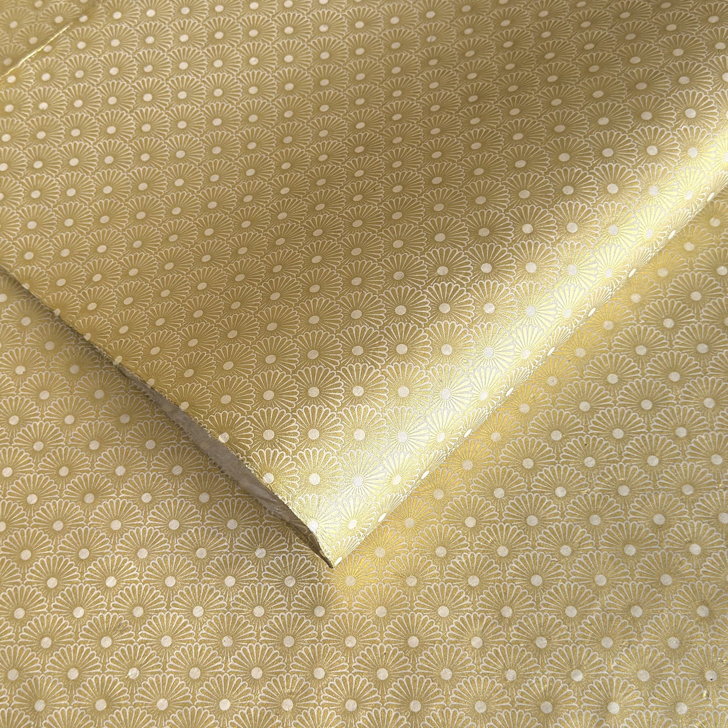 Nepalese handmade decorative lokta paper sheet with a gold metallic repeat floral pattern screen printed on an ivory lokta paper.