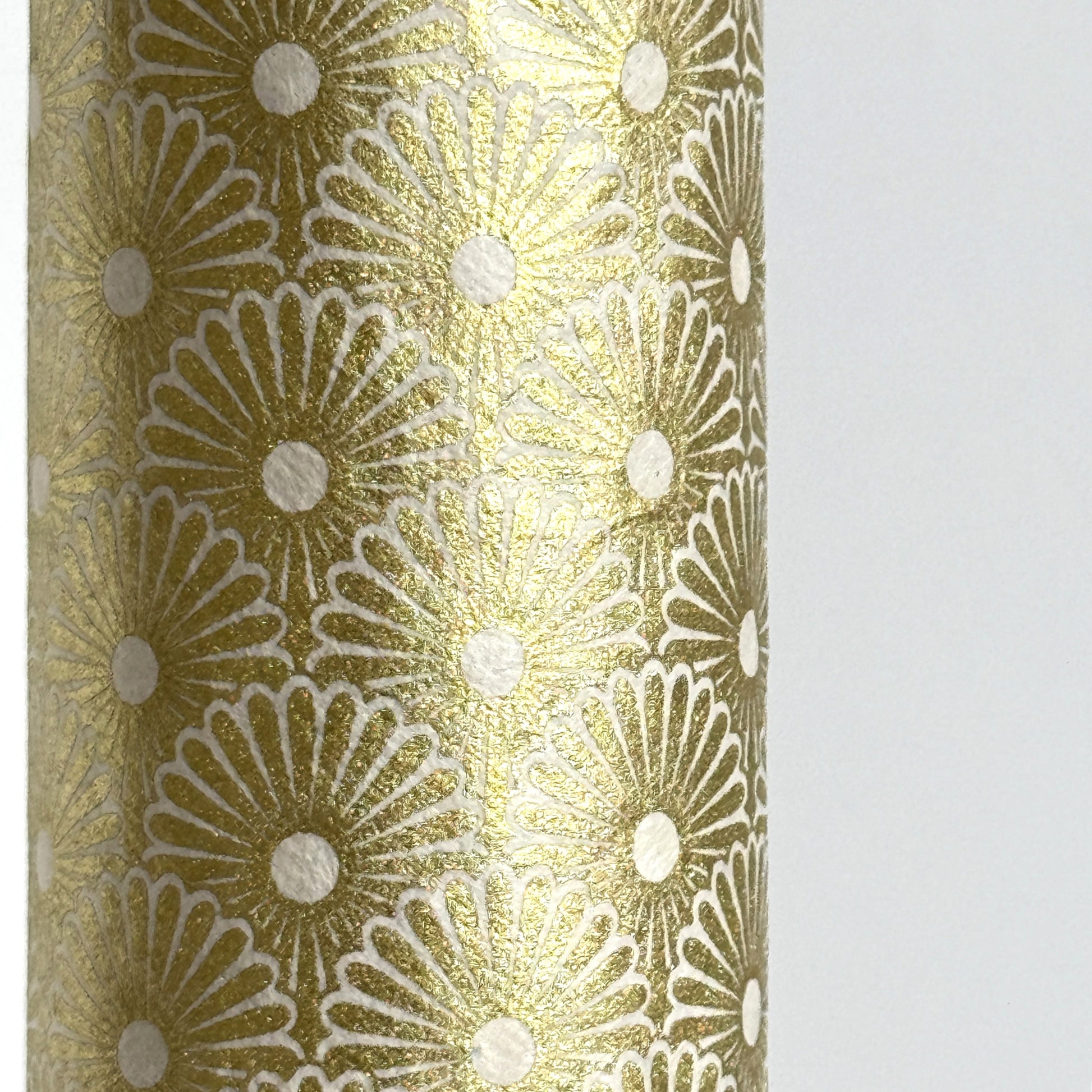 Nepalese handmade decorative lokta paper sheet with a gold metallic repeat floral pattern screen printed on an ivory lokta paper. Close up