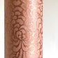 Nepalese handmade decorative lokta paper sheet with a metallic copper floral print screen printed on a blush pink lokta paper. close-up