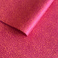 Nepalese handmade lokta paper sheet with a screen printed coral floral design on fuchsia lokta paper