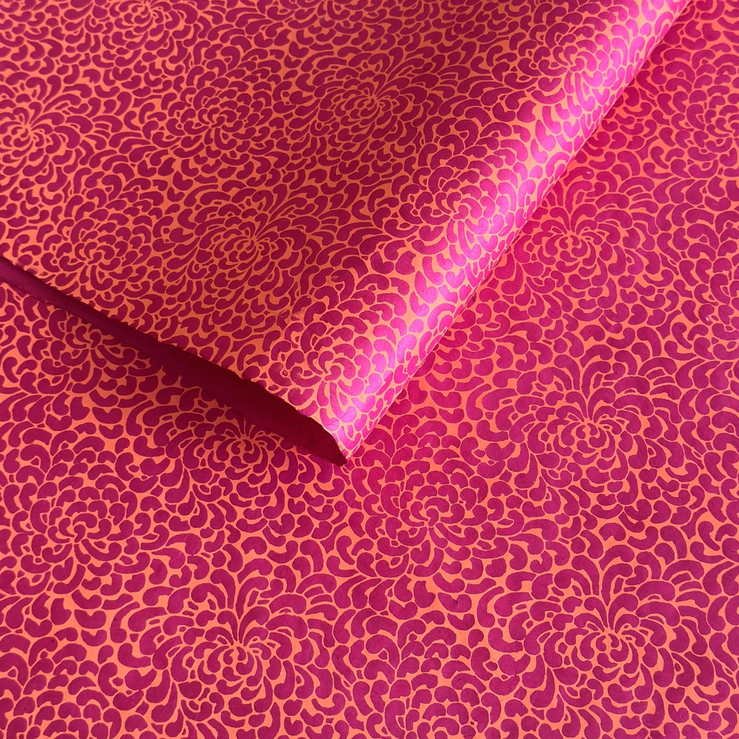 Nepalese handmade lokta paper sheet with a screen printed coral floral design on fuchsia lokta paper