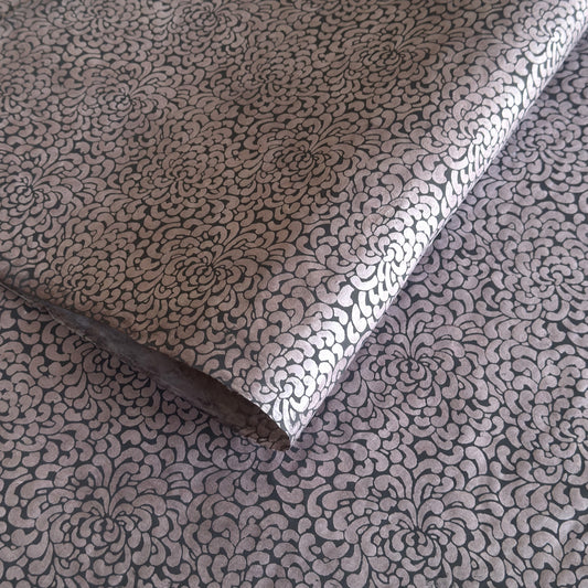 Nepalese handmade lokta paper sheet with a screen printed black floral design on slate lokta paper