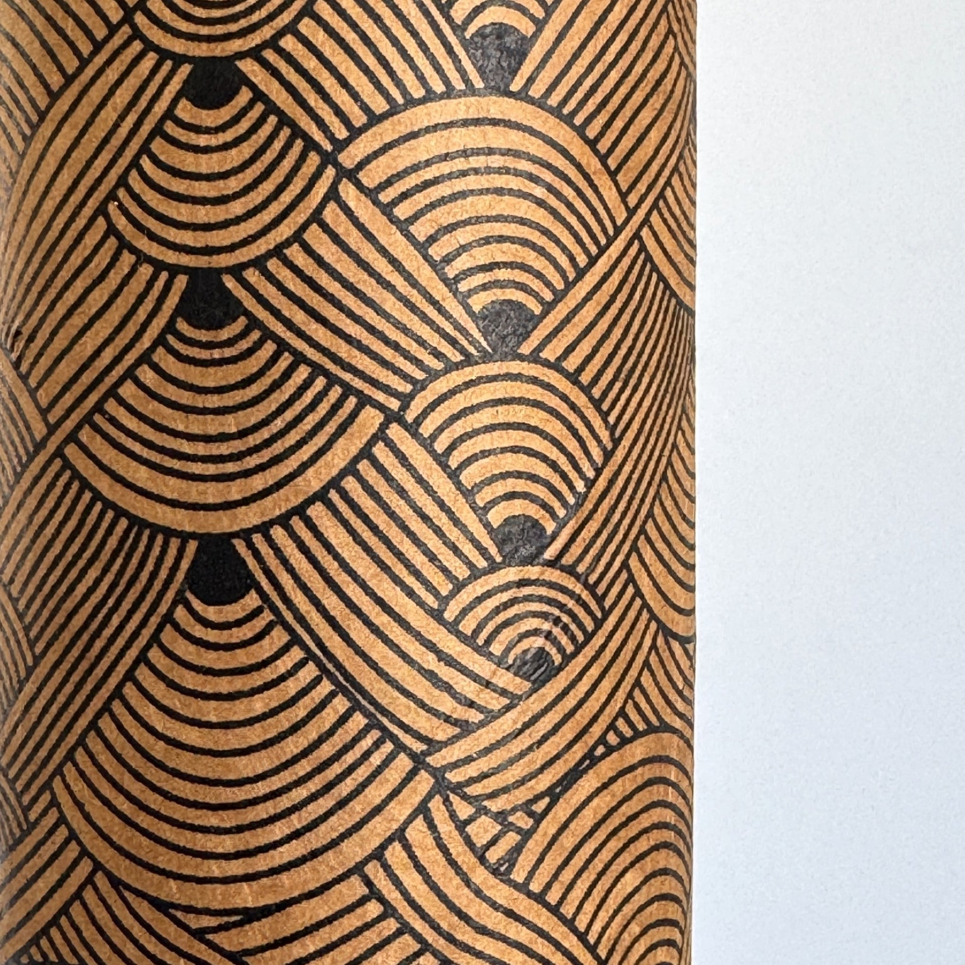 Nepalese handmade decorative lokta paper sheet with a fine lined black knots pattern screen printed on a brown lokta paper.