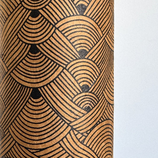 Nepalese handmade decorative lokta paper sheet with a fine lined black knots pattern screen printed on a brown lokta paper.