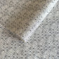 Nepalese handmade decorative lokta paper sheet with a fine lined black knots pattern screen printed on an ivory lokta paper.