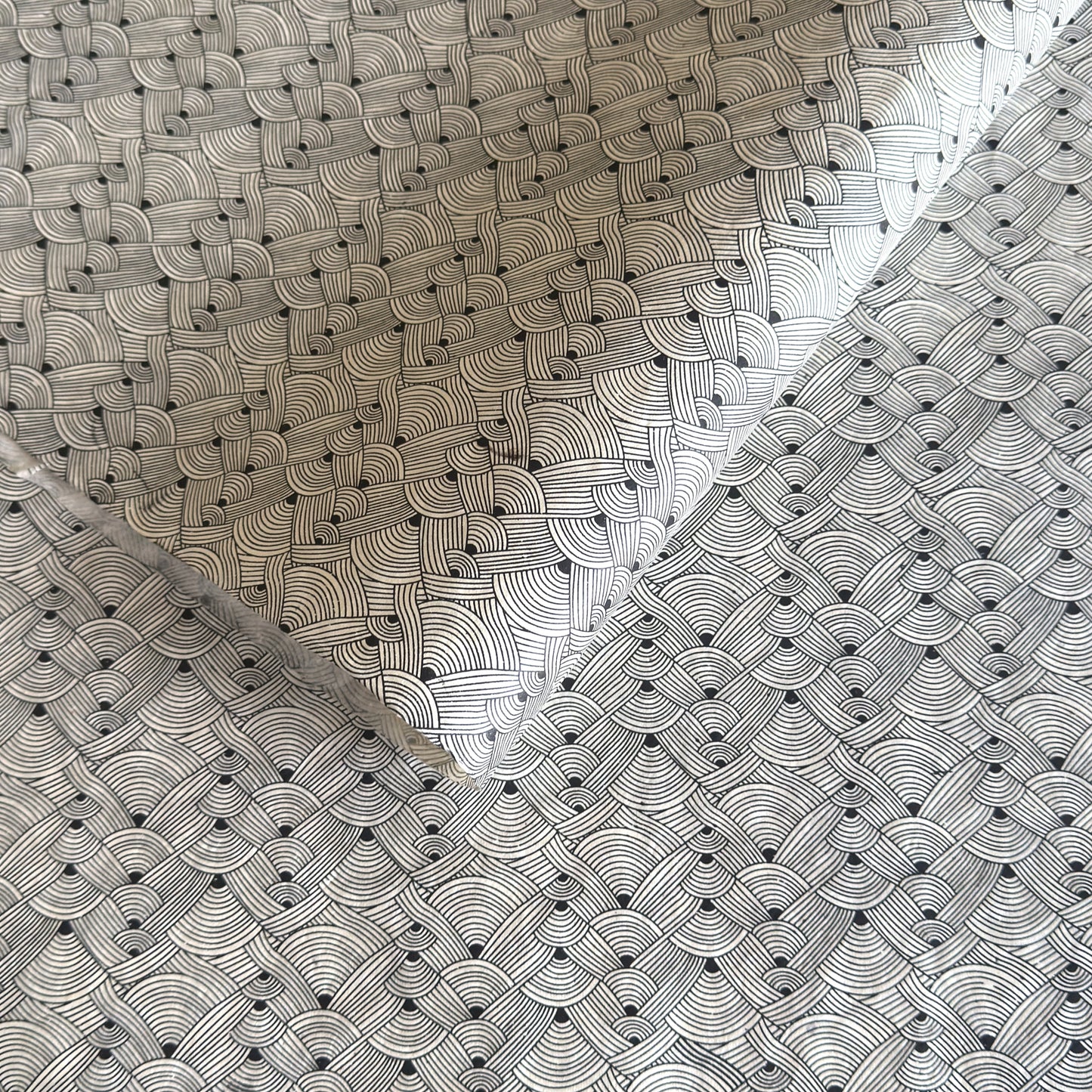 Nepalese handmade decorative lokta paper sheet with a fine lined black knots pattern screen printed on an ivory lokta paper.
