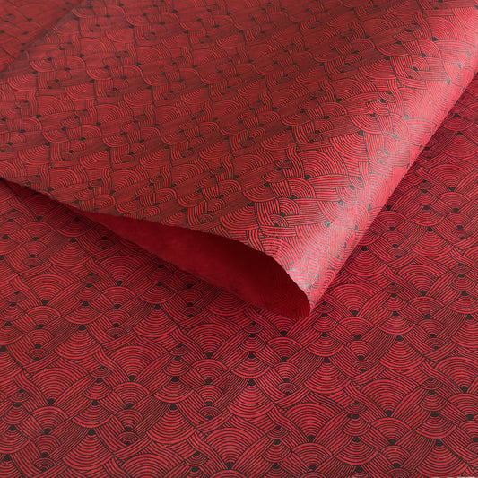 Nepalese handmade decorative lokta paper sheet with a fine lined black knots pattern screen printed on a red lokta paper.