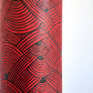 Nepalese handmade decorative lokta paper sheet with a fine lined black knots pattern screen printed on a red lokta paper.