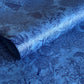 Detailed pattern of trees and flowers in dark blue screen-printed by hand on a blue lokta paper. 