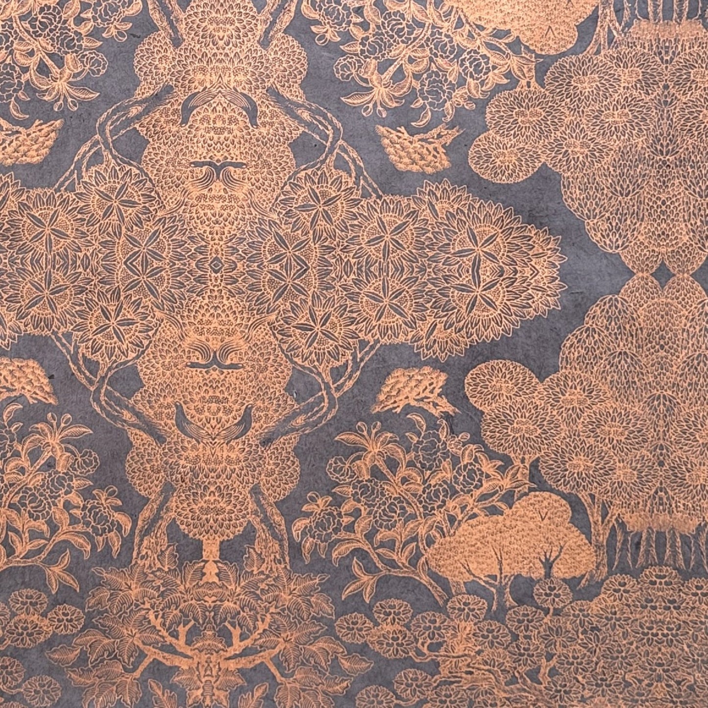 Nepalese handmade decorative lokta paper sheet with a detailed design of trees and flowers in copper screen printed on a dusty violet lokta paper.
