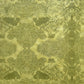 Nepalese handmade decorative lokta paper sheet with a detailed design of trees and flowers in dark green screen printed on a green lokta paper.